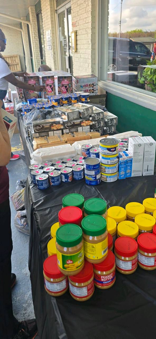 Tables of donated pantry food including peanut butter, canned goods and crackers
