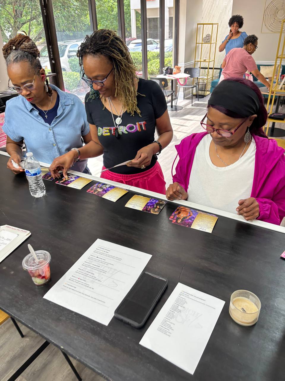 Women working through printed worksheets together at a Rich Girls Foundation session